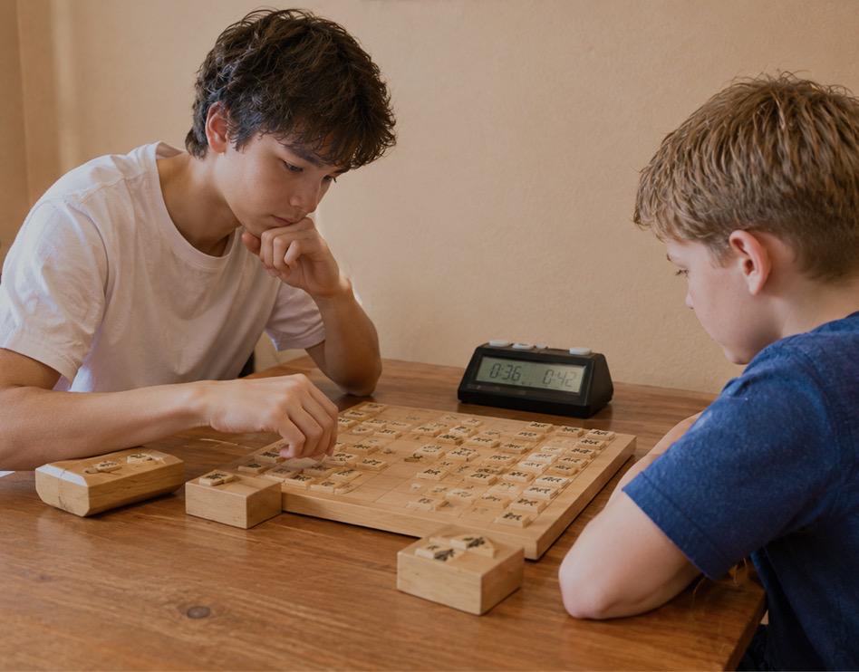 Two young players concentrating on a shogi game