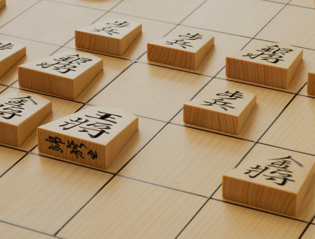Wooden shogi pieces arranged on a board